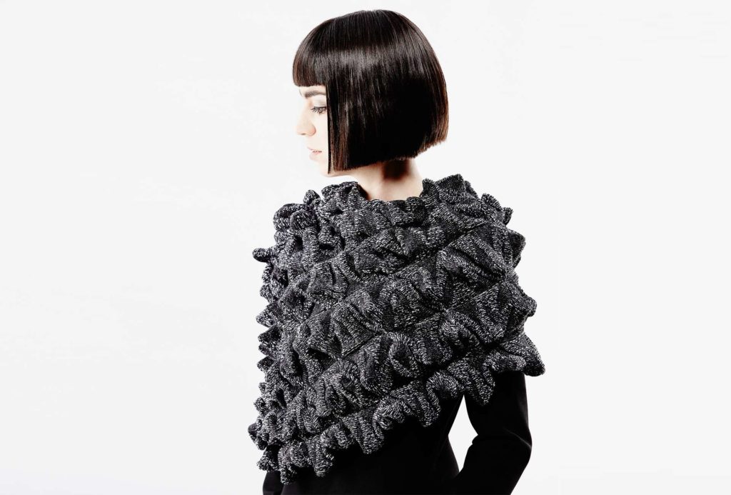 <em>OFI</em>, black and white, 2016, knit cape. 75% merino extrafine, 25% silk, width 55cm, height 65cm. Photo: Ingo Misiak.