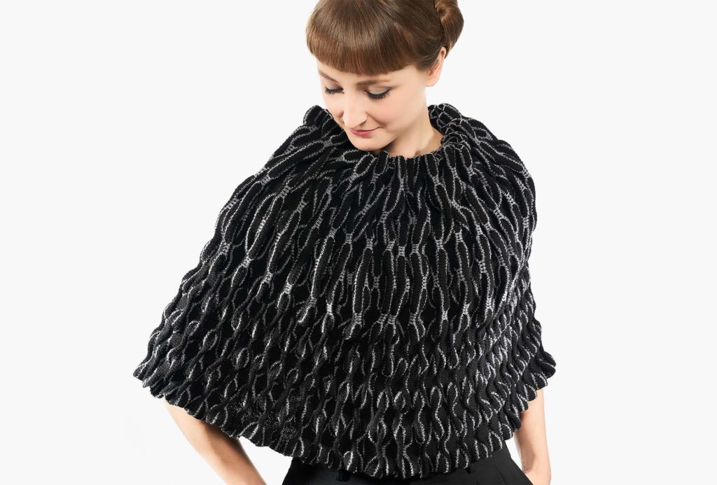 <em>WAVES</em>, pelerine black and gray, 2019, knitted. 95% merino extrafine, 5% silk, height 50cm, width 70cm. Photo: Ingo Misiak.