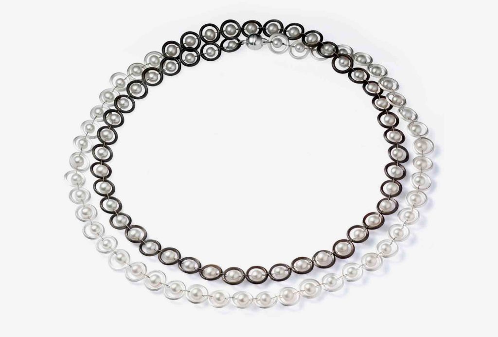 <em>Pearl row</em> necklace. Silver 925, silver black rhodinum-plated, white freshwater pearls, stainless steel rope.