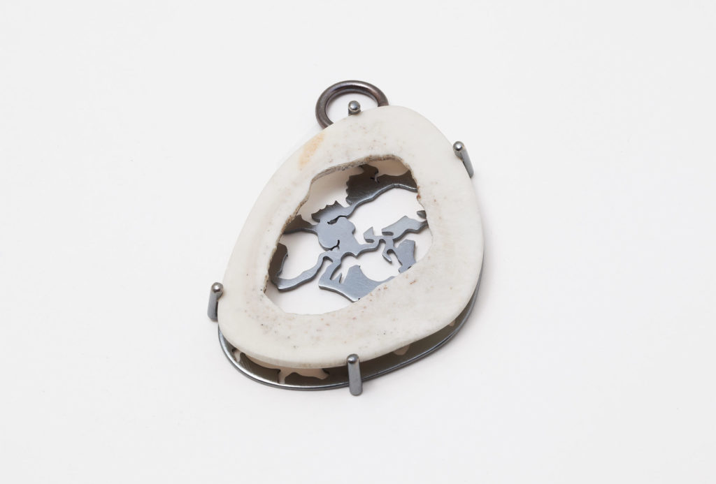 <em>Durchblick?</em> pendant. Sliced bovine bone, silver
