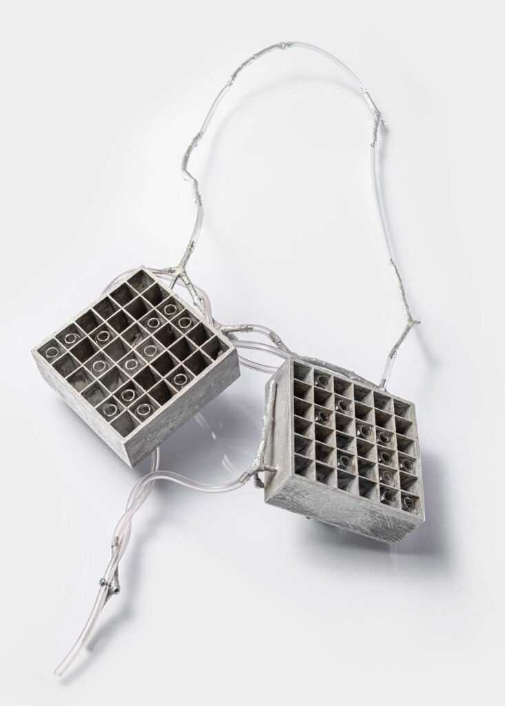 <em>Transfer 02</em> necklace, back, 2022. Aluminum, glass, 7.5 x 7.5 mm per element.
Length approx. 75 cm. 