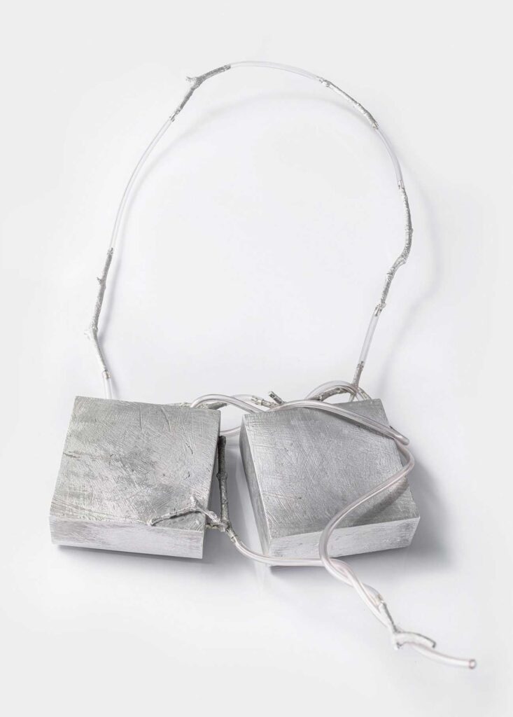 <em>Transfer 02</em> necklace, 2022. Aluminum, glass, 7.5 x 7.5 mm per element.
Length approx. 75 cm. 