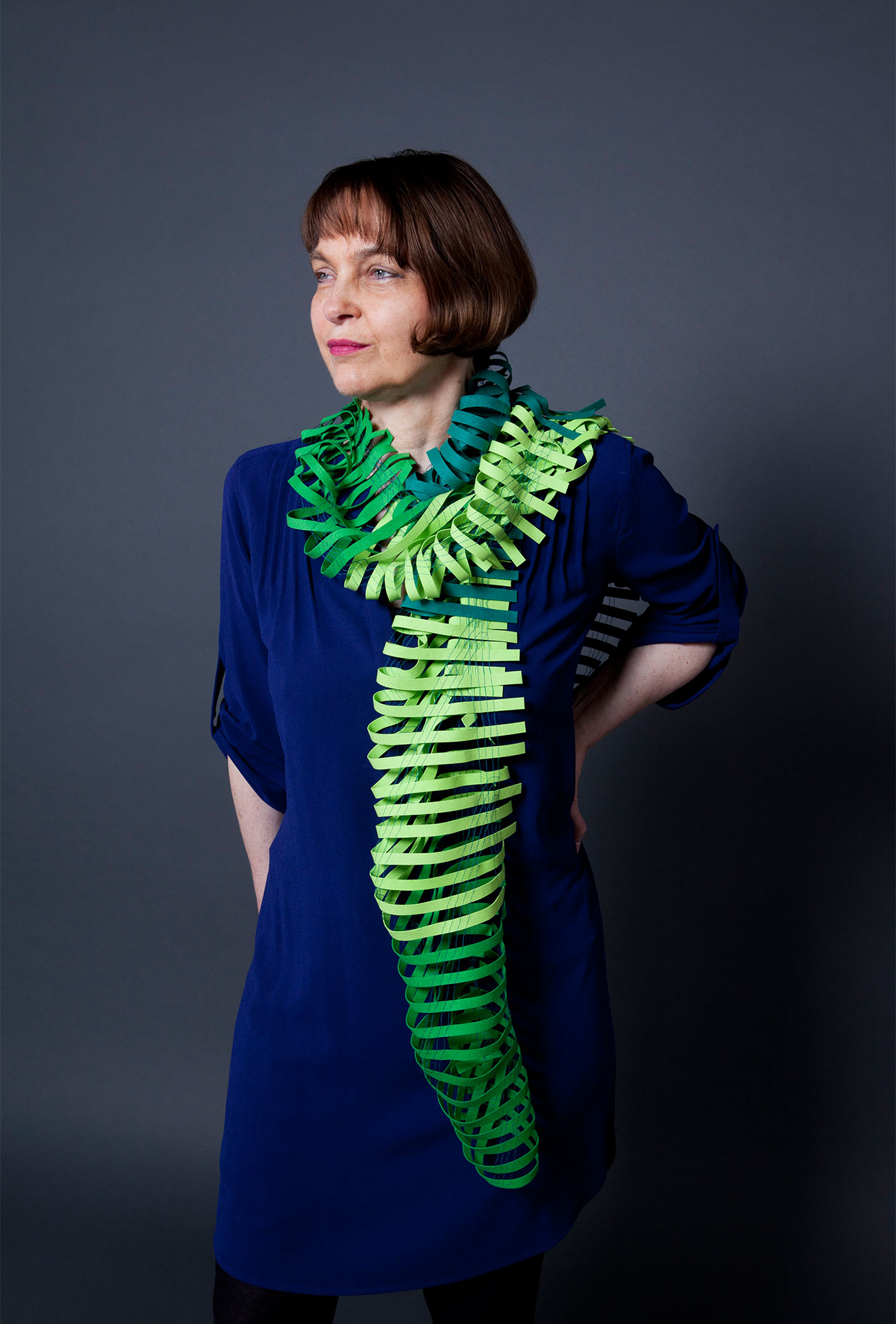 Ulrike Isensee with her scarf object. Sewn fabric strips with a leather effect