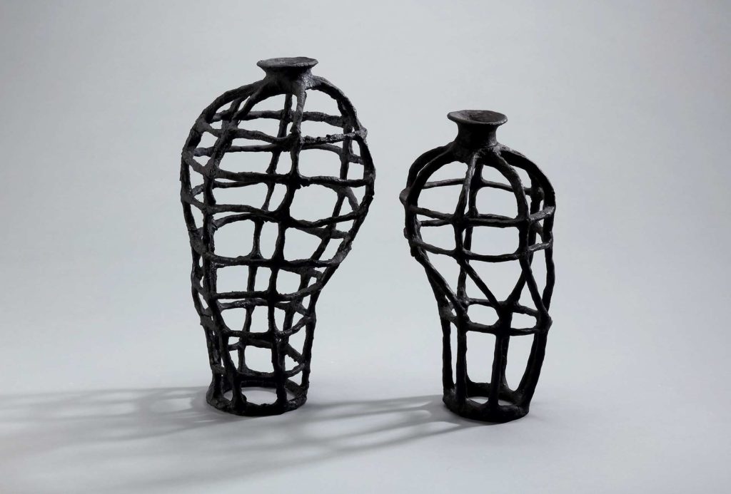 <em>Grid vases</em>, 2015. Porcelain on metal, 28x15 and 24x13 cm.