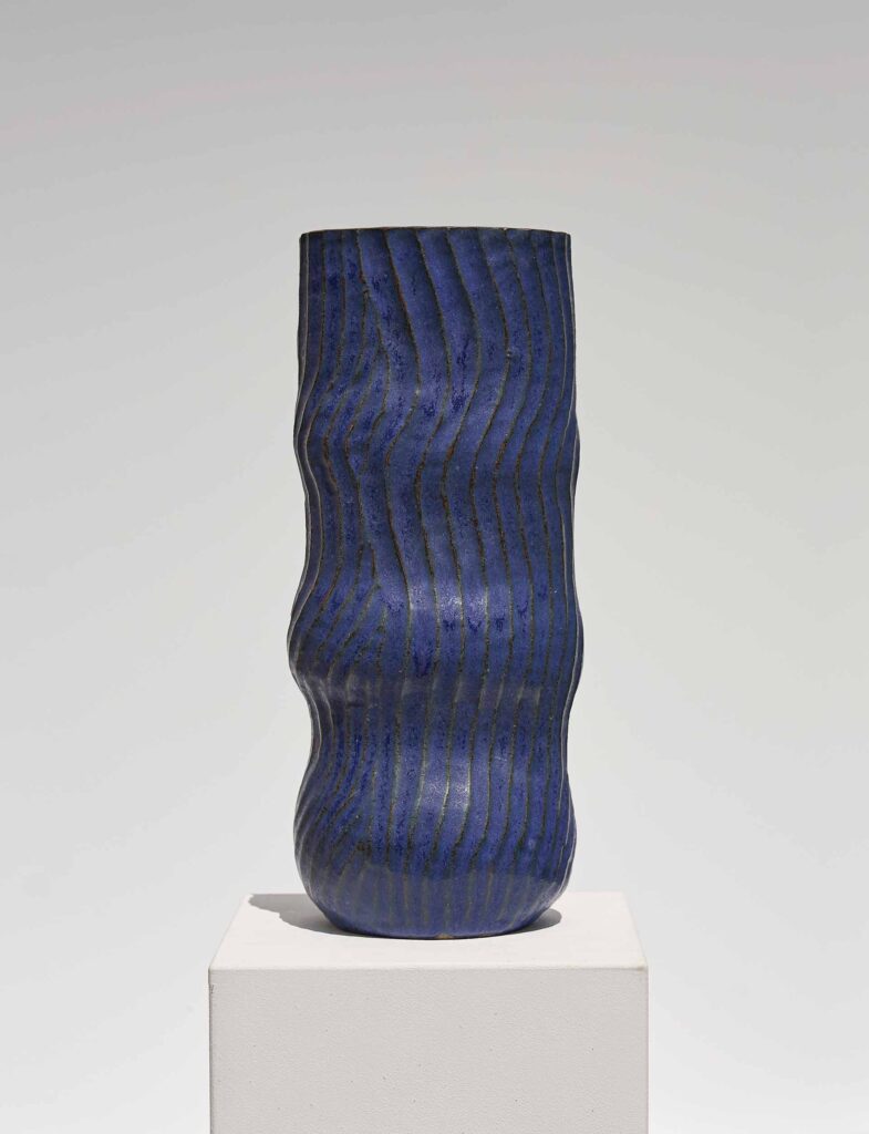 <em>Off-Beat</em> vase from the <em>Round & Round</em> series, 2024, blue on gray. Glazed stoneware, 15 x 15 x 34 cm.